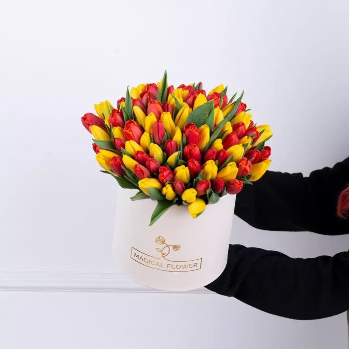 101 разноцветный тюльпан в шляпной кремовой коробке